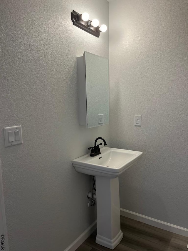 bathroom with hardwood / wood-style floors