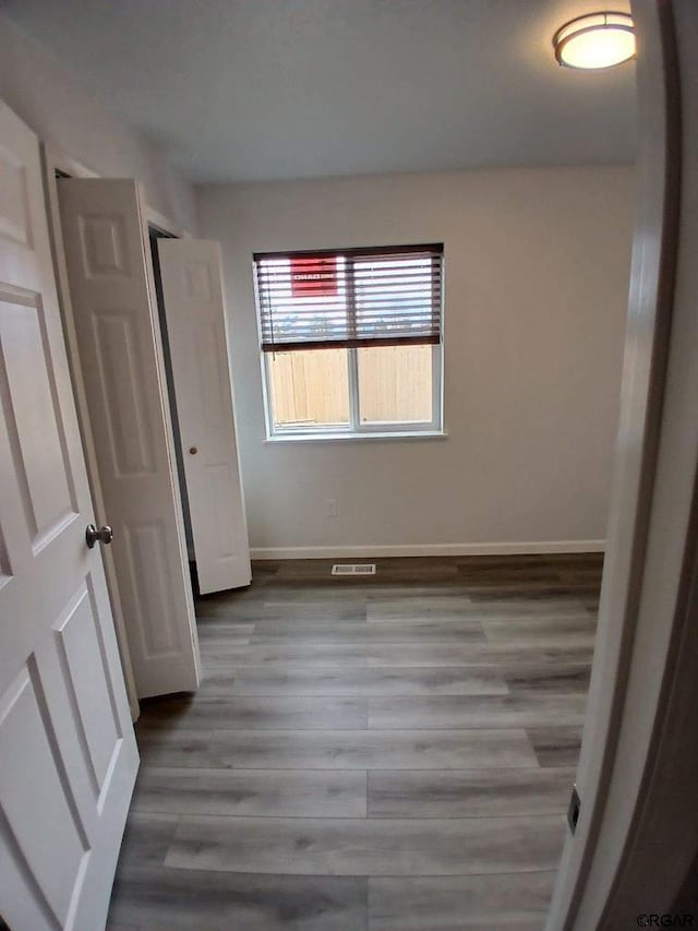 unfurnished bedroom featuring wood-type flooring