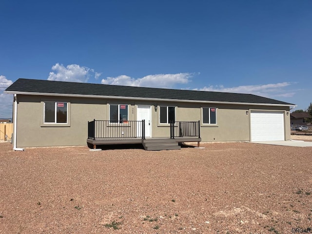 view of front of property featuring a wooden deck and a garage