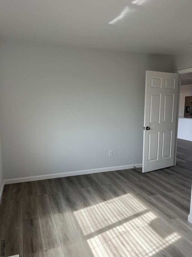 empty room with dark wood-type flooring