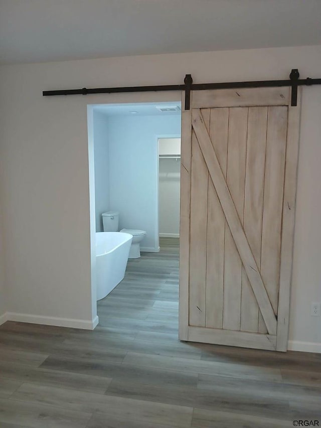 bathroom with wood-type flooring and toilet