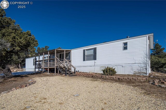 rear view of house featuring a deck