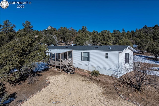 back of property featuring a deck