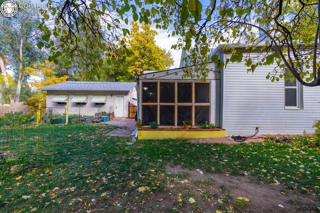 exterior space featuring a yard and a sunroom