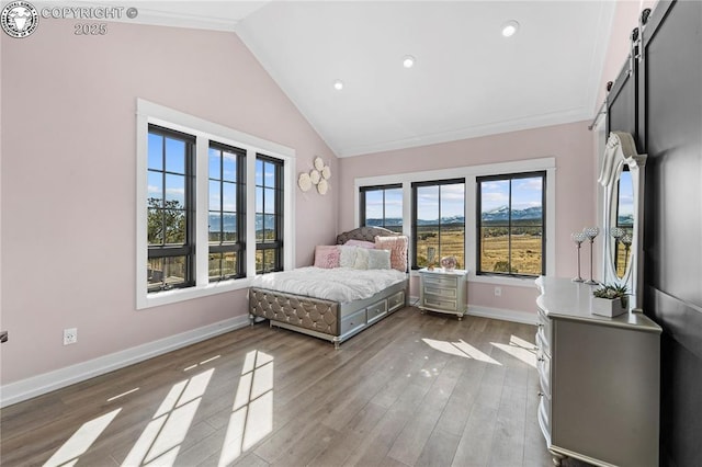 bedroom featuring a barn door, recessed lighting, baseboards, vaulted ceiling, and light wood-style floors