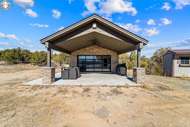 view of patio with a grill, a storage unit, and an outbuilding