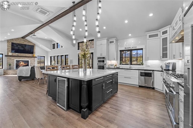 kitchen featuring white cabinetry, glass insert cabinets, and a center island