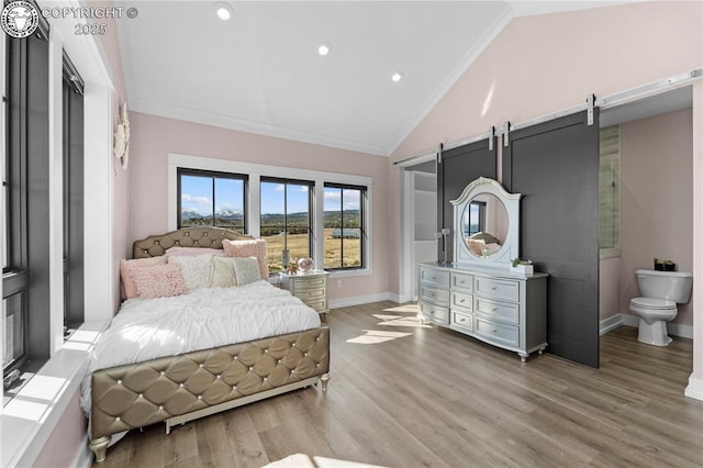 bedroom with vaulted ceiling, ornamental molding, light wood finished floors, and baseboards