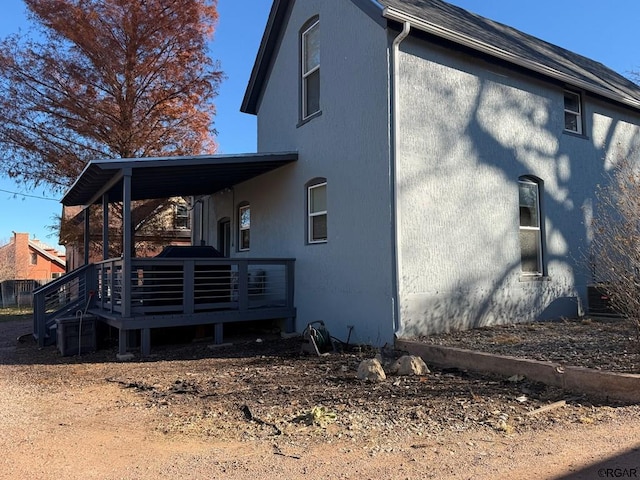 view of side of property with a deck