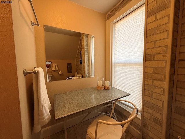 bathroom featuring lofted ceiling