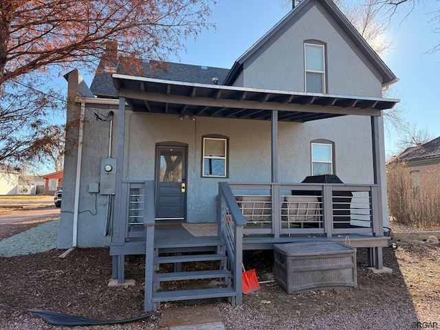 rear view of property with a porch