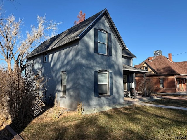 view of side of home with a yard