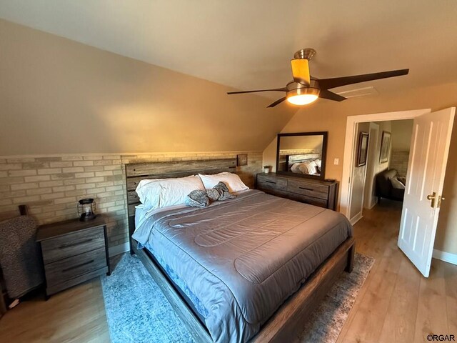 bedroom featuring vaulted ceiling, light hardwood / wood-style floors, and ceiling fan