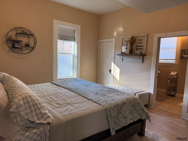 bedroom featuring wood-type flooring and multiple windows