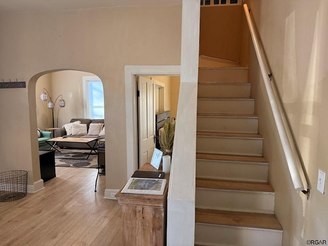 stairs featuring wood-type flooring