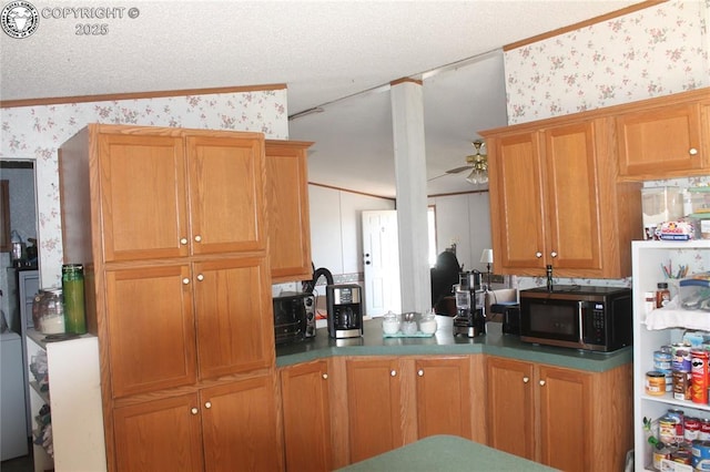 8 Cedar Ridge Rd, Williamsburg, CO 81226 - kitchen with wallpapered walls, stainless steel microwave, ceiling fan, ornamental molding, and a textured ceiling