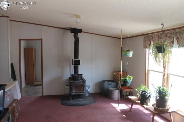 8 Cedar Ridge Rd, Williamsburg, CO 81226 - carpeted living room with a wood stove, a textured ceiling, and ornamental molding