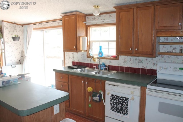 8 Cedar Ridge Rd, Williamsburg, CO 81226 - kitchen featuring white appliances, wallpapered walls, a sink, brown cabinets, and a textured ceiling