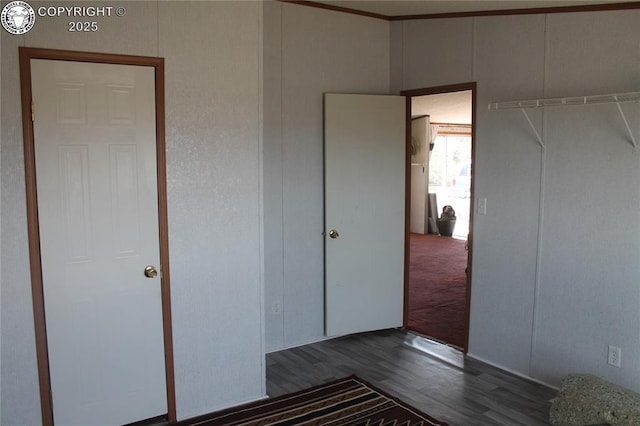 8 Cedar Ridge Rd, Williamsburg, CO 81226 - unfurnished bedroom featuring dark wood-type flooring and a decorative wall