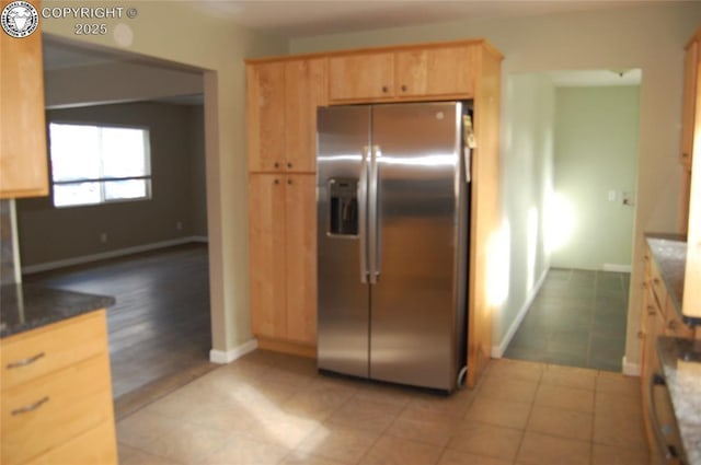 1207 Eugene Dr, Canon City, CO 81212 - kitchen featuring stainless steel fridge, light brown cabinetry, light tile patterned flooring, and baseboards