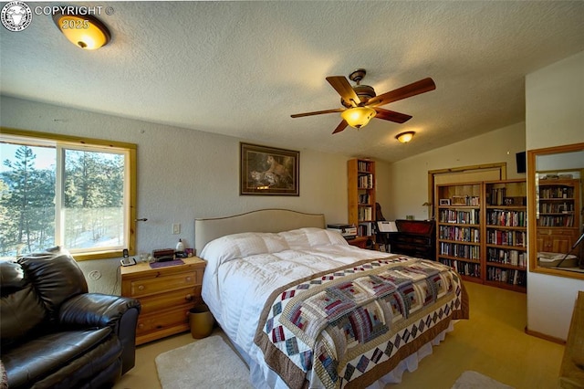 bedroom with vaulted ceiling, a textured ceiling, and ceiling fan