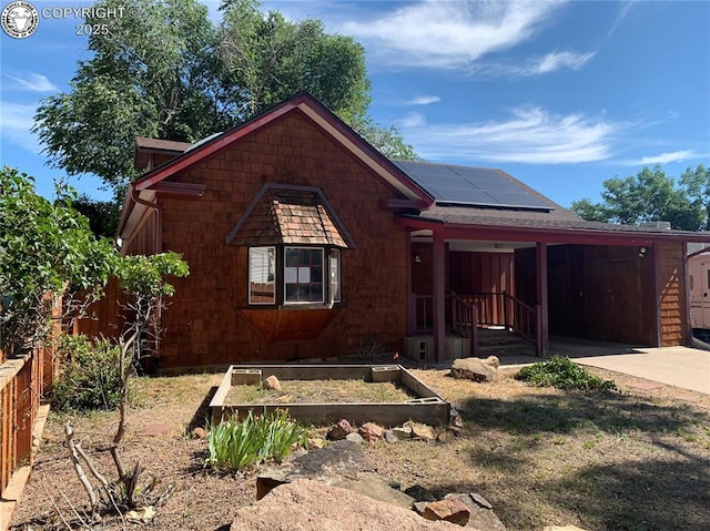 515 Mystic Ave, Canon City, CO 81212 - view of front of house with roof mounted solar panels, driveway, and a garden