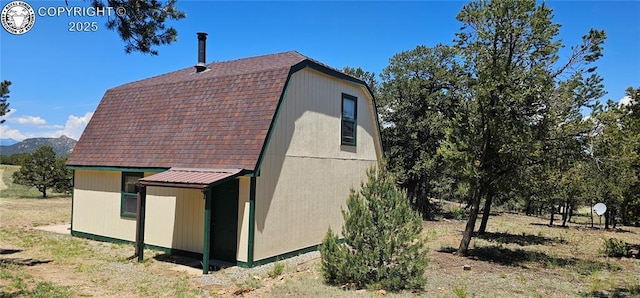 104 Sleepy Hollow Trl, Cotopaxi, CO 81223 - view of side of home featuring a gambrel roof, roof with shingles, and an outbuilding