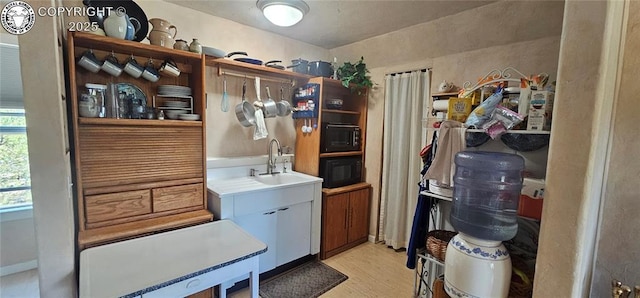 104 Sleepy Hollow Trl, Cotopaxi, CO 81223 - kitchen featuring open shelves, black microwave, light wood finished floors, and light countertops