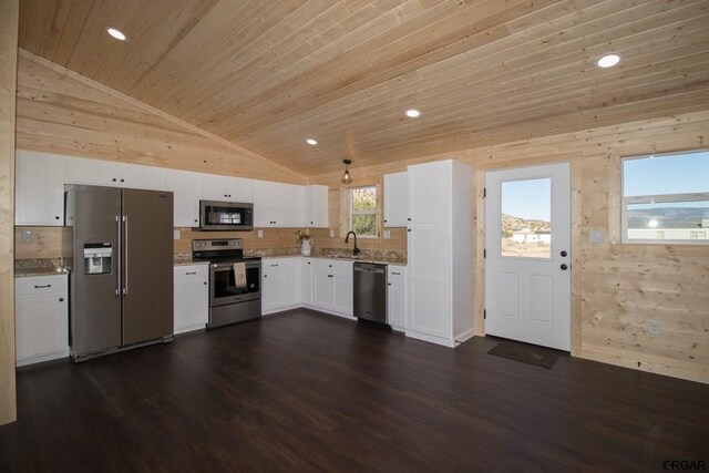 kitchen featuring vaulted ceiling, appliances with stainless steel finishes, sink, white cabinets, and wooden ceiling