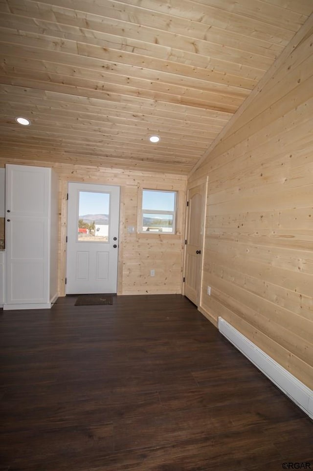 interior space with dark wood-type flooring, lofted ceiling, wooden walls, and wooden ceiling