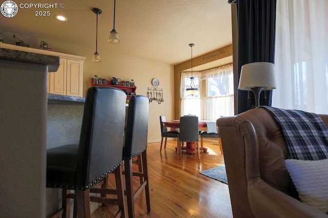 dining area featuring wood finished floors and recessed lighting