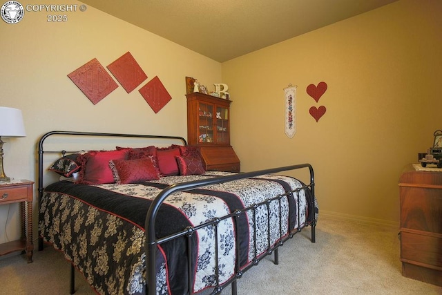 bedroom with light carpet and baseboards