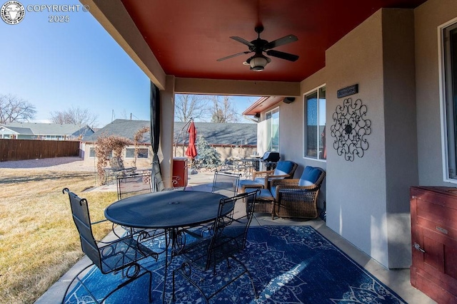 view of patio / terrace with ceiling fan, fence, and outdoor dining area