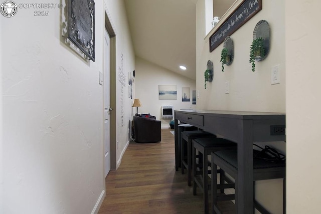 corridor with dark wood-type flooring, recessed lighting, and baseboards