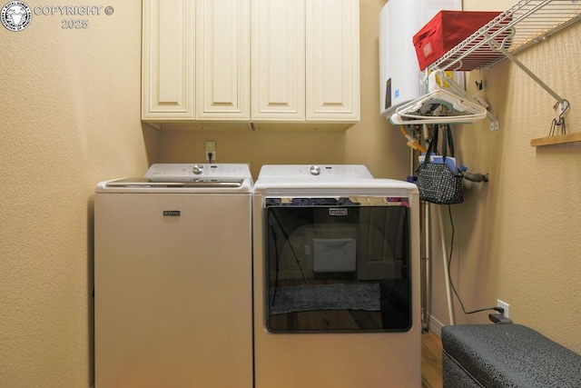 clothes washing area with cabinet space and washing machine and clothes dryer