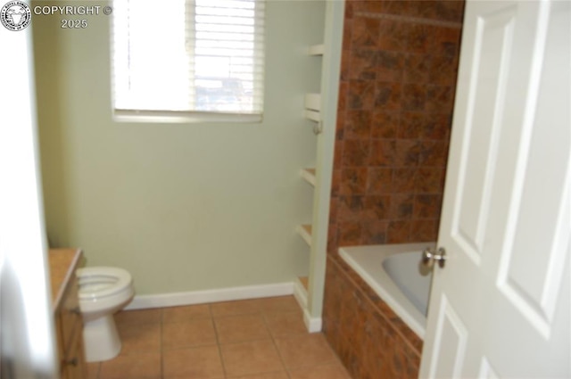 full bathroom with tile patterned flooring, vanity, tiled shower / bath, and toilet