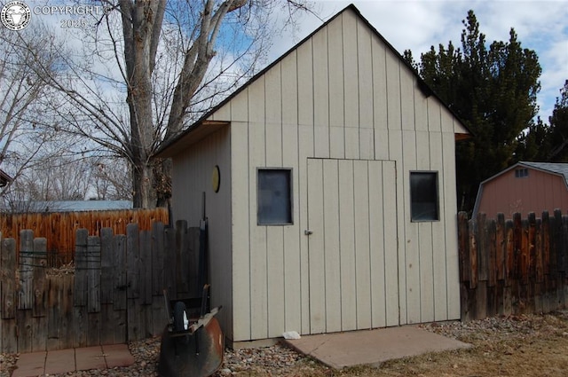 view of shed featuring fence