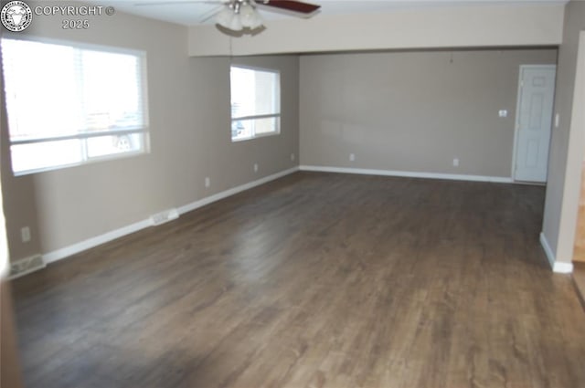 spare room featuring dark hardwood / wood-style floors and ceiling fan