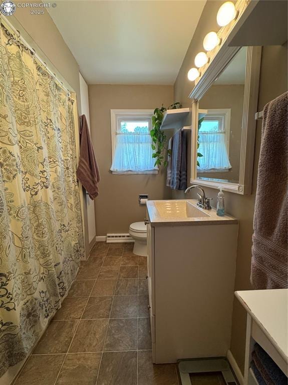 1230 N 6th St, Canon City, CO 81212 - bathroom with vanity, baseboard heating, toilet, baseboards, and tile patterned flooring