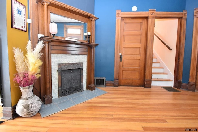 unfurnished living room with hardwood / wood-style floors and a fireplace