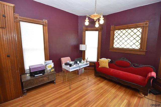 sitting room featuring light hardwood / wood-style flooring and a chandelier