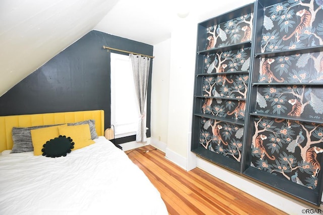 bedroom featuring lofted ceiling and hardwood / wood-style flooring