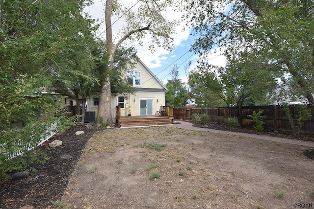 back of house with central AC and a deck