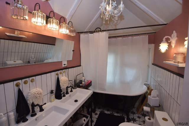 bathroom with lofted ceiling, sink, and toilet