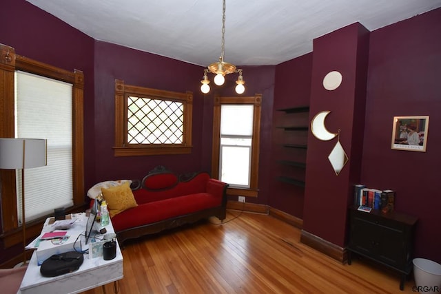 living room with hardwood / wood-style floors and an inviting chandelier