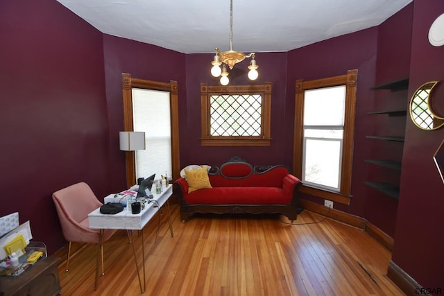 sitting room with light hardwood / wood-style floors and a chandelier