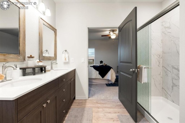 bathroom featuring vanity, wood-type flooring, ceiling fan, and walk in shower