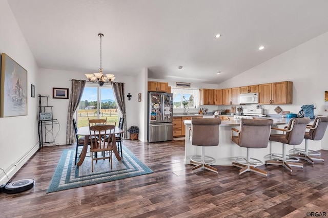 kitchen featuring lofted ceiling, stainless steel refrigerator, stove, hanging light fixtures, and a chandelier