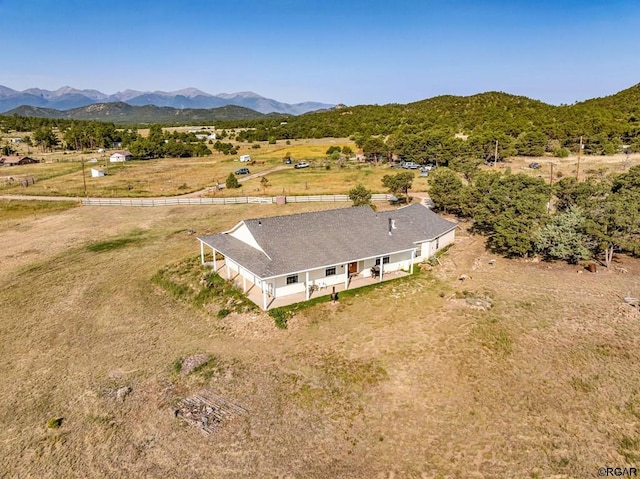 drone / aerial view featuring a mountain view and a rural view