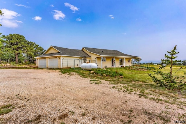 ranch-style house with a porch and a garage